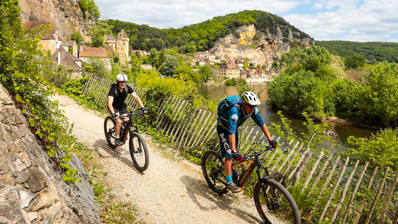 deux hommes à VTT sur une piste cyclable le long de la rivière de la Dordogne à proximité de La Roque-Gageac